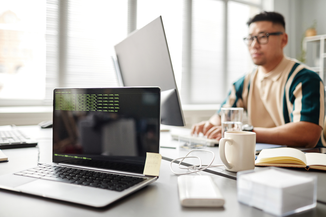 background-image-laptop-with-green-code-lines-screen-it-developers-office-with-person-worki